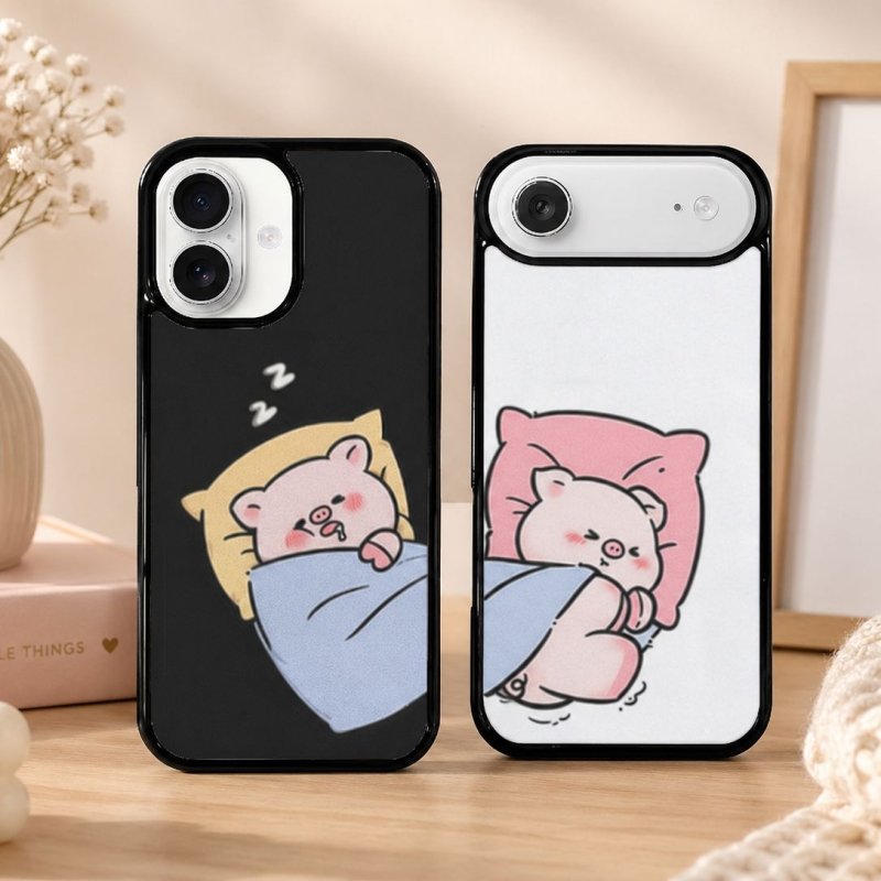 Two phone cases with cartoon pigs on pillows