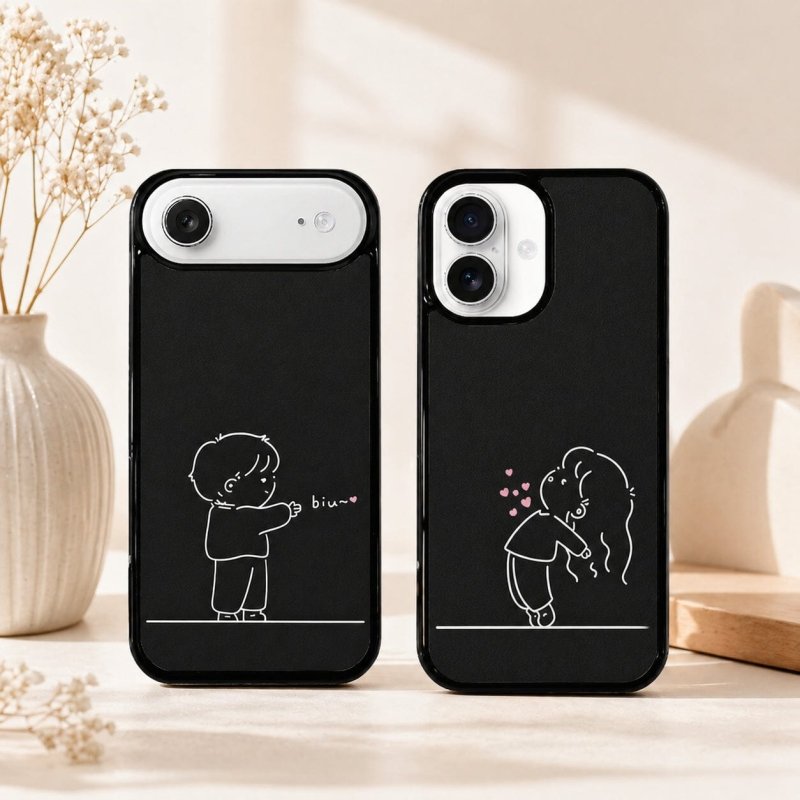 Two black phone cases with white illustrations of a boy and girl.