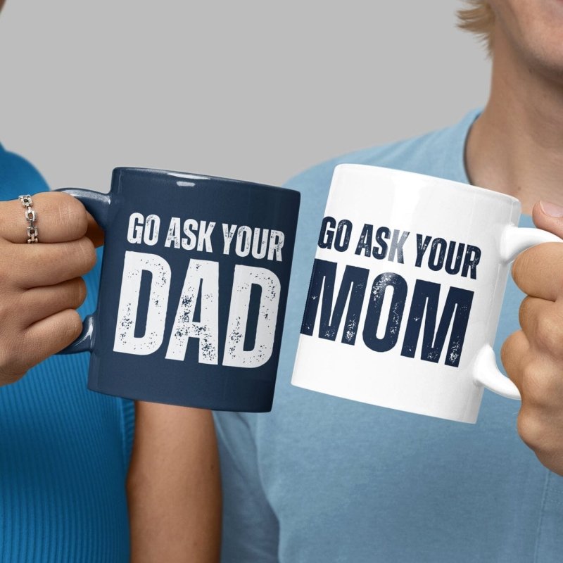 Two people holding mugs with text 'Go Ask Your Dad' and 'Go Ask Your Mom'.